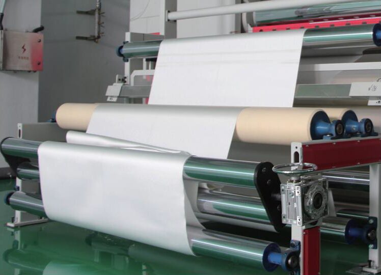 Cloth passing through calender rollers