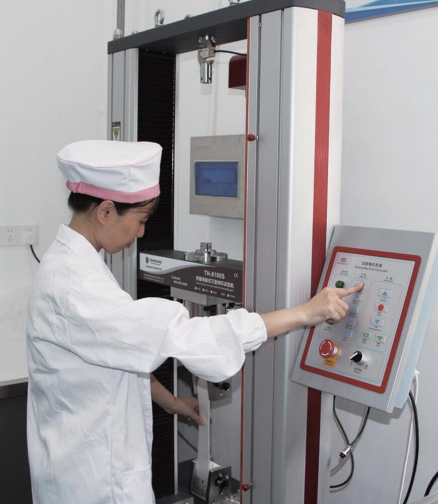 Operator inspecting cloth at a test station