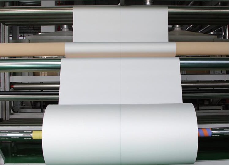 Heat-setting the woven cloth over a roller
