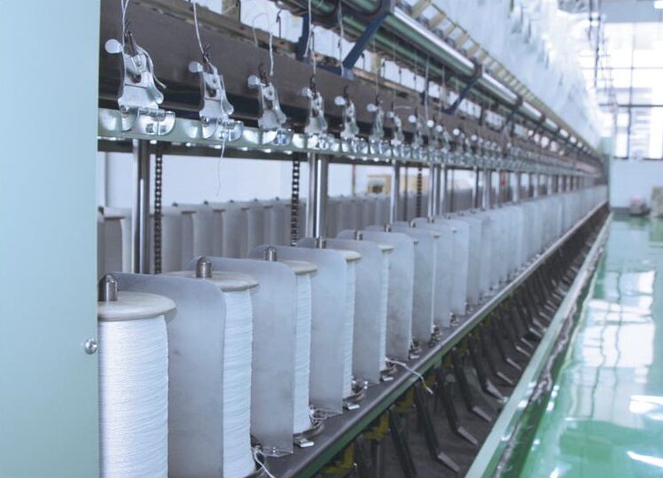Rows of yarn spools on a twisting frame