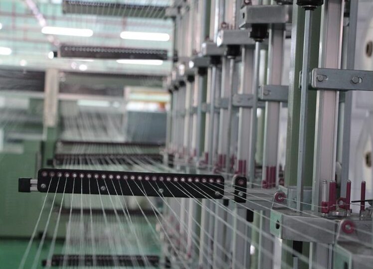 Warp threads drawn onto a beam