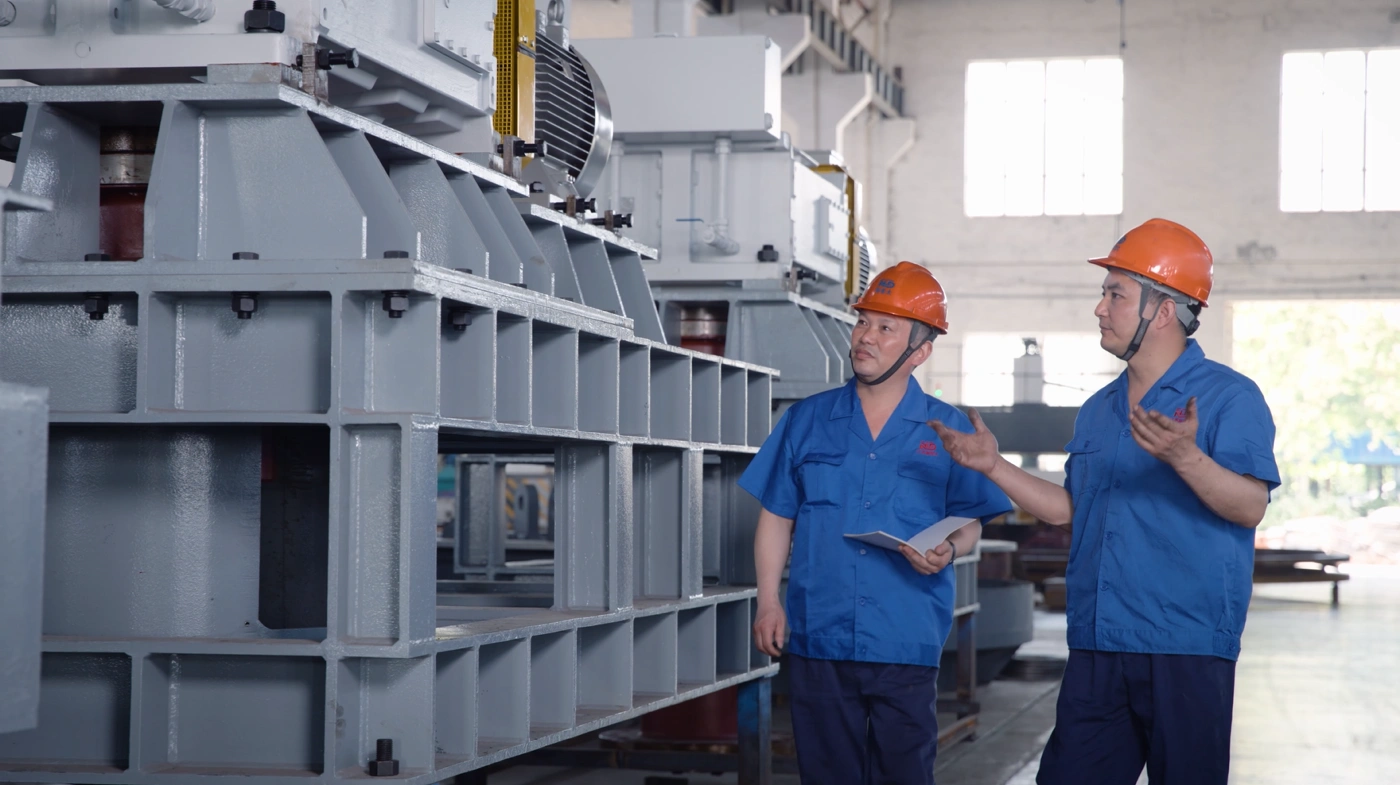 Engineers Inspecting Heavy-Duty Mining Equipment in Manufacturing Plant